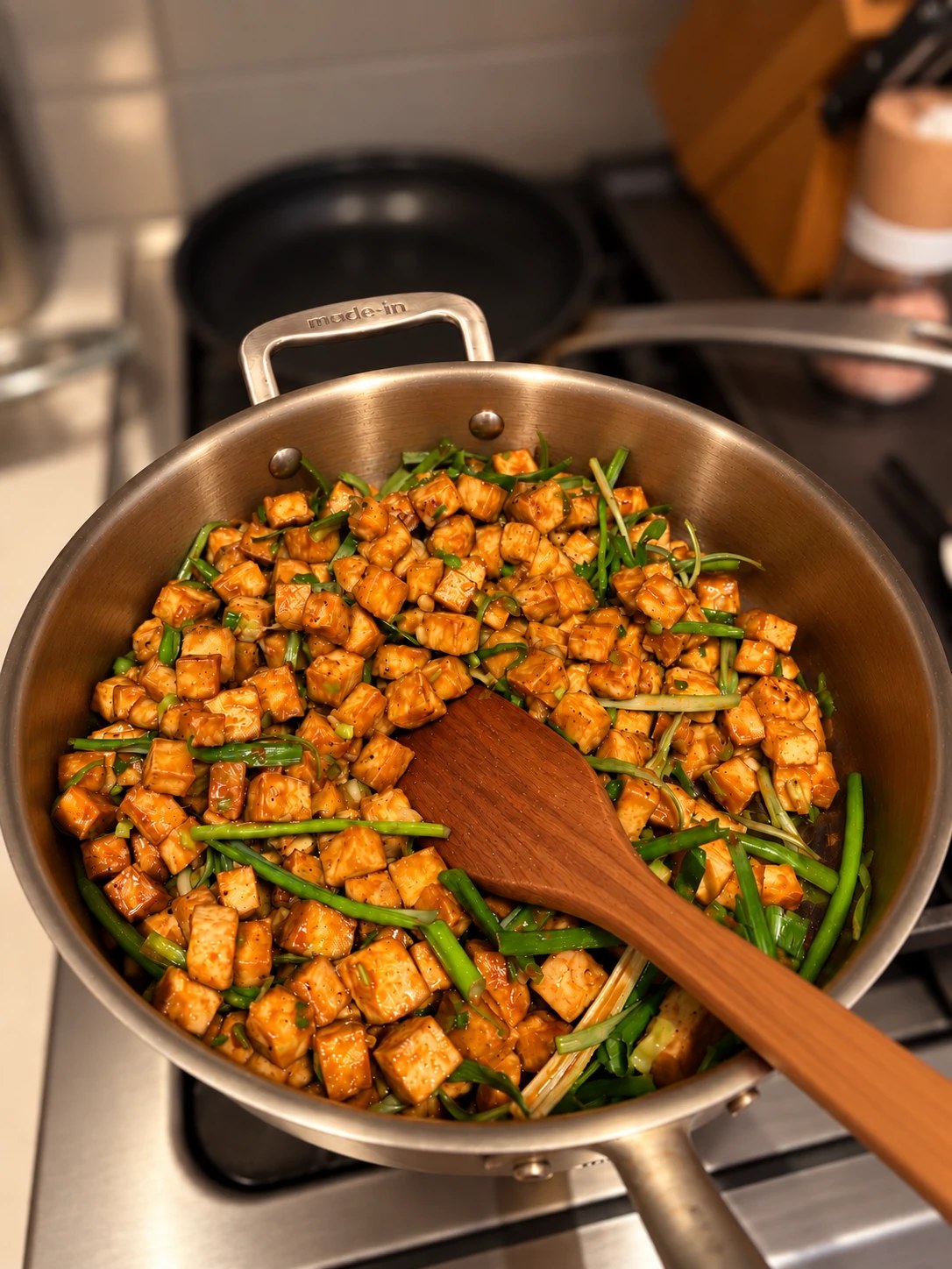 Diced char siu tofu with scallions in a skillet